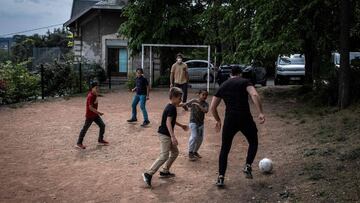 Children and educators play a ball game on April 20, 2020 in the "L'etoile du berger" institution for children in social or parental distress in La MulatixE8re near Lyon, during the 35th day of a strict lockdown in France aimed at curbing t