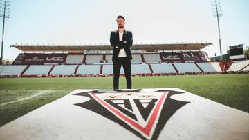 Rubén de la Barrera, entrenador del Albacete Balompié, posa en el Carlos Belmonte frente al escudo del equipo manchego.