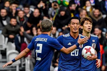 Japan's defender Makino Tomoaki (C) celebrates 