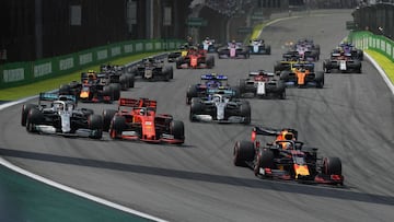Red Bull's Dutch driver Max Verstappen (R) leads the pack followed by Ferrari's German driver Sebastian Vettel (C) and Mercedes' British driver Lewis Hamilton (L) during the F1 Brazil Grand Prix, at the Interlagos racetrack in Sao Paulo, Brazil on November 17, 2019. (Photo by Carl DE SOUZA / AFP)