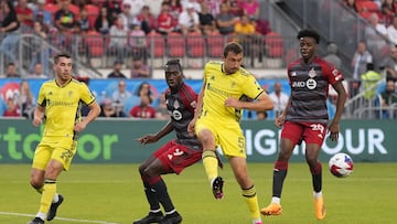 Jun 10, 2023; Toronto, Ontario, CAN; Nashville SC defender Jack Maher (5) battles for the ball against Toronto FC forward C.J. Sapong (9) in the first half at BMO Field. Mandatory Credit: Nick Turchiaro-USA TODAY Sports