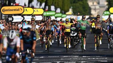Jumbo-Visma teamDanish rider Jonas Vingegaard wearing the overall leader's yellow jersey (C)celebrates flanked by his teammate Jumbo-Visma team's Belgian rider Wout Van Aert (2-R) wearing the sprinter's green jersey and Jumbo-Visma team's Belgian rider Tiesj Benoot (2-L)Jumbo-Visma team's American rider Sepp Kuss and Jumbo-Visma team's French rider Christophe (R) as they crosses the finish line of the 109th edition of the Tour de France cycling race, after the 21st and final stage, 115,6 km between La Defense Arena in Nanterre, outside Paris, and the Champs-Elysees in Paris, France, on July 24, 2022. (Photo by Anne-Christine POUJOULAT / AFP) (Photo by ANNE-CHRISTINE POUJOULAT/AFP via Getty Images)