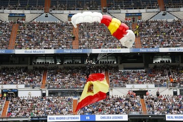 Parachuters land on the field before the game.