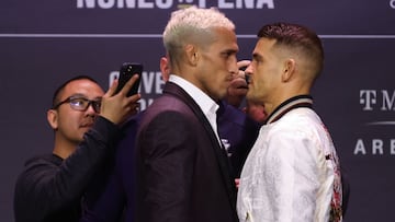 LAS VEGAS, NEVADA - DECEMBER 09: Charles Oliveira of Brazil and Dustin Poirier face off during the UFC 269 press conference at MGM Grand Garden Arena on December 09, 2021 in Las Vegas, Nevada.   Carmen Mandato/Getty Images/AFP
 == FOR NEWSPAPERS, INTERNET