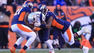 DENVER, CO - DECEMBER 18: Running back Dion Lewis #33 of the New England Patriots is hit by cornerback Aqib Talib #21 and inside linebacker Todd Davis #51 of the Denver Broncos in the second quarter of a game at Sports Authority Field at Mile High on December 18, 2016 in Denver, Colorado.   Sean M. Haffey/Getty Images/AFP
 == FOR NEWSPAPERS, INTERNET, TELCOS &amp; TELEVISION USE ONLY ==