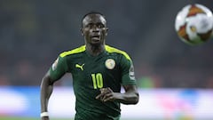 (FILES) In this file photo taken on February 06, 2022 Senegal's forward Sadio Mane looks at the ball during the Africa Cup of Nations (CAN) 2021 final football match between Senegal and Egypt at Stade d'Olembe in Yaounde. - Sadio Man� is on Senegal's list for the 2022 World Cup announced on November 11, 2022 in Dakar by coach Aliou Ciss�, despite the recent injury which compromises his chances of playing. (Photo by Kenzo TRIBOUILLARD / AFP)