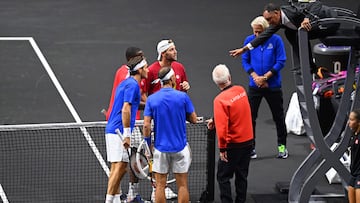 Team World captain John McEnroe, players and umpire discuss an incident where the ball went through the net in the game between Switzerland's Roger Federer (R) and Spain's Rafael Nadal of Team Europe against USA's Jack Sock and USA's Frances Tiafoe of Team World during their 2022 Laver Cup men's doubles tennis match at the O2 Arena in London on September 23, 2022. - Roger Federer brings the curtain down on his spectacular career in a "super special" match alongside long-time rival Rafael Nadal at the Laver Cup in London on Friday. (Photo by Glyn KIRK / AFP) / RESTRICTED TO EDITORIAL USE