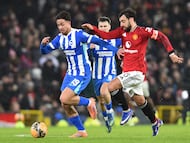 Brighton's Greek striker #19 Charalampos Kostoulas (L) vies with Manchester United's Portuguese midfielder #08 Bruno Fernandes (R) during the English FA Cup third round football match between Manchester United and Brighton and Hove Albion at Old Trafford Stadium in Manchester, north west England, on January 11, 2026. (Photo by PETER POWELL / AFP) / RESTRICTED TO EDITORIAL USE. No use with unauthorized audio, video, data, fixture lists, club/league logos or 'live' services. Online in-match use limited to 120 images. An additional 40 images may be used in extra time. No video emulation. Social media in-match use limited to 120 images. An additional 40 images may be used in extra time. No use in betting publications, games or single club/league/player publications. /
