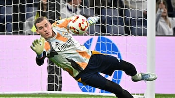 Real Madrid's Ukrainian goalkeeper #13 Andriy Lunin warms up prior the Spanish Copa del Rey (King's Cup) semi-final second leg football match between Real Madrid CF and Real Sociedad at the Santiago Bernabeu stadium in Madrid on April 1, 2025. (Photo by JAVIER SORIANO / AFP)