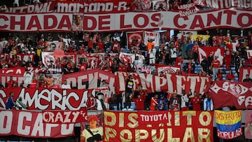 Fans of America de Cali cheer for their team during the Copa Sudamericana group stage football match between Uruguay's Racing and Colombia's America de Cali at the Centenario stadium in Montevideo on April 2, 2025. (Photo by EITAN ABRAMOVICH / AFP) (Photo by EITAN ABRAMOVICH/AFP via Getty Images)