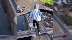 Un ni&ntilde;o salta entre peque&ntilde;as islas sobre una autopista con coches que pasa por debajo a mucha altura. 