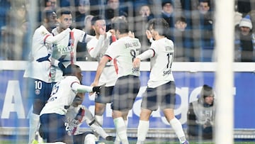 PSG players including Paris Saint-Germain's Portuguese defender #25 Nuno Mendes (bottom L) celebrate after their team's second goal during the French L1 football match between RC Strasbourg Alsace and Paris Saint-Germain (PSG) at the Stade de la Meinau in Strasbourg, eastern France, on February 1, 2026. (Photo by SEBASTIEN BOZON / AFP)