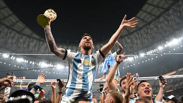 LUSAIL CITY, QATAR - DECEMBER 18: Lionel Messi of Argentina celebrates with the FIFA World Cup Qatar 2022 Winner's Trophy on the shoulders of former teammate Sergio Aguero after the team's victory during the FIFA World Cup Qatar 2022 Final match between Argentina and France at Lusail Stadium on December 18, 2022 in Lusail City, Qatar. (Photo by Shaun Botterill - FIFA/FIFA via Getty Images)