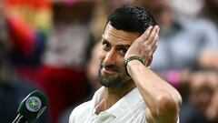 Winner Serbia's Novak Djokovic speaks during an interview and reacts to the cheering of the crowd at the end of his men's singles tennis match against Denmark's Holger Rune on the eighth day of the 2024 Wimbledon Championships at The All England Lawn Tennis and Croquet Club in Wimbledon, southwest London, on July 8, 2024. (Photo by Ben Stansall / AFP) / RESTRICTED TO EDITORIAL USE