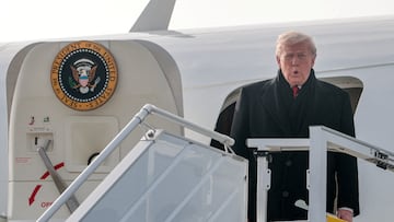 The US president was headed to Switzerland, but had to return to Maryland, ahead of a speech to the World Economic Forum.