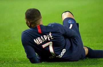 Paris Saint-Germain's French forward Kylian Mbappe sits on the ground as he celebrates after scoring a goal during the French L1 football match between Paris Saint-Germain (PSG) and FC Nantes (FCN) at the Parc des Princes in Paris, on December 4, 2019. (P