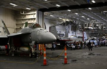 An F-18 fighter aircraft sits in the hanger of the Theodore Roosevelt  (CVN 71), a nuclear-powered aircraft carrier, anchored in Busan Naval Base in Busan, South Korea, June 22, 2024.  Song Kyung-Seok/Pool via REUTERS