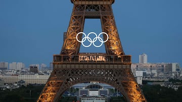This photograph shows the Olympic Rings on the Eiffel Tower ahead of the traditional fireworks marking the annual Bastille Day in Paris, on July 14, 2024. The torch relay ahead of the Paris Olympics reached the French capital for the first time, with organisers hoping to build enthusiasm for the Games (Photo by Dimitar DILKOFF / AFP)