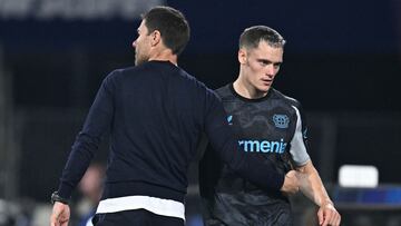 Bayer Leverkusen's Spanish coach Xabi Alonso (L) speaks with Bayer Leverkusen's German midfielder #10 Florian Wirtz (R) on the sidelines during the UEFA Champions League 1st round day 1 football match between Feyenoord and Bayer Leverkusen at The De Kuip Stadium, in Rotterdam on September 19, 2024. (Photo by JOHN THYS / AFP)