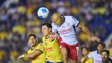 Ramon Juarez (L) of America fights for the ball with Javier Chicharito Hernandez (R) of Guadalajara during the round of 16 second leg match between America and Guadalajara as part of the CONCACAF Champions Cup 2025, at Ciudad de los Deportes Stadium on March 12, 2025 in Mexico City, Mexico.