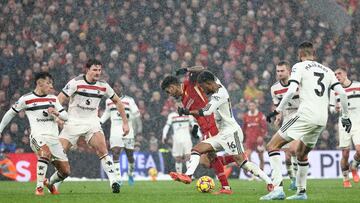 Liverpool's Colombian midfielder #07 Luis Diaz (C) is surrounded by United players during the English Premier League football match between Liverpool and Manchester United at Anfield in Liverpool, north west England on January 5, 2025. (Photo by Darren Staples / AFP) / RESTRICTED TO EDITORIAL USE. No use with unauthorized audio, video, data, fixture lists, club/league logos or 'live' services. Online in-match use limited to 120 images. An additional 40 images may be used in extra time. No video emulation. Social media in-match use limited to 120 images. An additional 40 images may be used in extra time. No use in betting publications, games or single club/league/player publications. /
