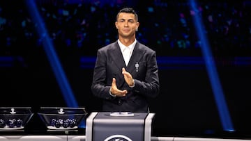Portugal's national team player and Saudi Al-Nassr's forward Cristiano Ronaldo applauds on stage during the ceremony of the draw for the group stage of the 2024-2025 UEFA Champions League football tournament, at the Grimaldi Forum in Monaco on August 29, 2024. (Photo by Valery HACHE / AFP)