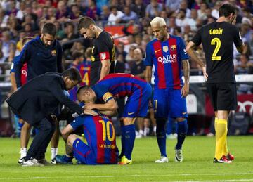 Messi is consoled by team-mate Andrés Iniesta after his injury against Atlético.