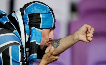 Soccer Football - FIFA Club World Cup Semi Final - Gremio FBPA vs CF Pachuca - Hazza Bin Zayed Stadium, Al Ain City, United Arab Emirates - December 12, 2017 Gremio fan kisses his tattoo as he celebrates after the match