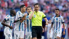Los jugadores de la Real Sociedad protestan la decisión del árbitro de pitar 
un penalti a favor del atlético.