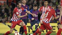 Barcelona&#039;s Argentinian forward Lionel Messi (C) vies with Atletico Madrid&#039;s Uruguayan defender Diego Godin (L) during the Spanish league football match between FC Barcelona and Club Atletico de Madrid at the Camp Nou stadium in Barcelona on Apr