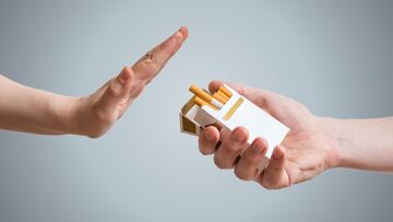 Quitting smoking concept. Hand is refusing cigarette offer. TABACO CAJETILLA DE TABACO