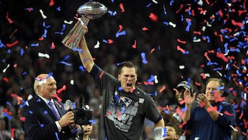 (FILES) This file photo taken on February 5, 2017 shows Tom Brady #12 of the New England Patriots as he holds the Vince Lombardi Trophy as Head coach Bill Belichick (R) looks on after defeating the Atlanta Falcons 34-28 in overtime during Super Bowl 51 at NRG Stadium in Houston, Texas.
New England Patriots quarterback Tom Brady said February 14, 2017 he had no problem with team-mates choosing to skip a likely White House visit following their Super Bowl victory. So far six Patriots players -- Martellus Bennett, LeGarrette Blount, Devin McCourty, Dont'a Hightower, Chris Long and Alan Branch -- have confirmed they will not attend the traditional reception for NFL championship-winning teams.
/ AFP PHOTO / Timothy A. CLARY
