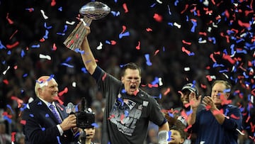 (FILES) This file photo taken on February 5, 2017 shows Tom Brady #12 of the New England Patriots as he holds the Vince Lombardi Trophy as Head coach Bill Belichick (R) looks on  after defeating the Atlanta Falcons 34-28 in overtime during Super Bowl 51 at NRG Stadium  in Houston, Texas.
 New England Patriots quarterback Tom Brady said February 14, 2017 he had no problem with team-mates choosing to skip a likely White House visit following their Super Bowl victory. So far six Patriots players -- Martellus Bennett, LeGarrette Blount, Devin McCourty, Dont&#039;a Hightower, Chris Long and Alan Branch -- have confirmed they will not attend the traditional reception for NFL championship-winning teams.
  / AFP PHOTO / Timothy A. CLARY