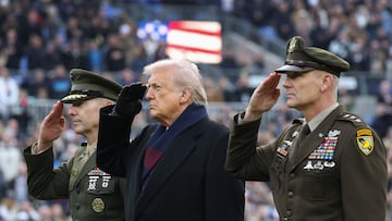 BALTIMORE, MARYLAND - DECEMBER 13: U.S. President Donald Trump (C) salutes as he attends the 126th Army-Navy Game between the Army Black Knights and the Navy Midshipmen at M&T Bank Stadium on December 13, 2025 in Baltimore, Maryland. The teams are competing for the Commander-in-Chief's Trophy, with President Trump attending the rivalry for the second consecutive year. Tasos Katopodis/Getty Images/AFP (Photo by TASOS KATOPODIS / GETTY IMAGES NORTH AMERICA / Getty Images via AFP)
