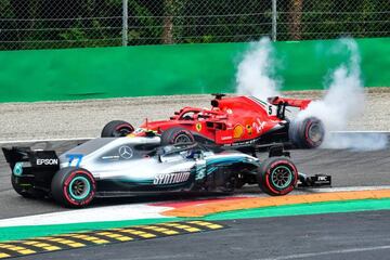 TOPSHOT - Mercedes' Finnish driver Valtteri Bottas (front) drives past Ferrari's German driver Sebastian Vettel's car after Vettel crashed with Mercedes' British driver Lewis Hamilton during the Italian Formula One Grand Prix at the Autodromo Nazionale ci