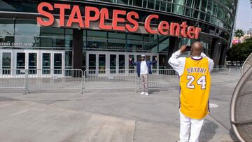 (FILES) In this file photo taken on March 14, 2021 people take photos in front of the Staples Center awhere the 63rd Annual Grammy Awards are taking place in Los Angeles, California. - The Los Angeles Lakers' famed home, the Staples Center, is to be