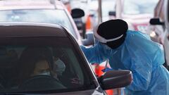 A nurse takes a swab sample at a drive-through coronavirus disease (COVID-19) test site at the University of Texas El Paso in El Paso, Texas, U.S., October 27, 2020. REUTERS/Paul Ratje