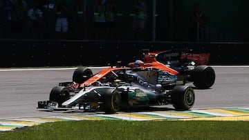 Formula One F1 - Brazilian Grand Prix 2017 - Sao Paulo, Brazil - November 12, 2017 Mercedes' Lewis Hamilton and McLaren's Fernando Alonso in action during the race REUTERS/Paulo Whitaker