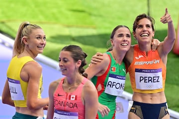 Portugal's Salome Afonso and Spain's Marta Perez react after the women's 1500m heat of the athletics event at the Paris 2024 Olympic Games at Stade de France in Saint-Denis, north of Paris, on August 6, 2024. (Photo by Martin  BERNETTI / AFP)