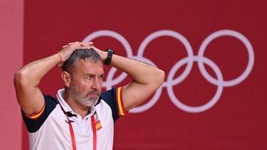 Spain's coach Carlos Enrique Viver Arza looks on during the women's preliminary round group B handball match between France and Spain of the Tokyo 2020 Olympic Games at the Yoyogi National Stadium in Tokyo on July 27, 2021. (Photo by Martin BERNETTI / AFP