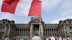 FILE PHOTO: A demonstrator waves a Peruvian flag during a protest against the government of President Pedro Castillo in front of the Palace of Justice, the seat of Peru&#039;s Supreme Court, in Lima, Peru October 8, 2021. REUTERS/Angela Ponce/File Photo