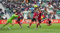 ELCHE, SPAIN - MARCH 19: Giorgi Mamardashvili of Valencia CF dives to save a shot from Enzo Roco of Elche during the LaLiga Santander match between Elche CF and Valencia CF at Estadio Manuel Martinez Valero on March 19, 2022 in Elche, Spain. (Photo by Ait