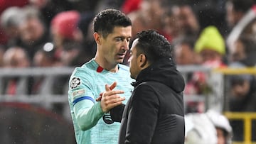 Barcelona's Polish forward #09 Robert Lewandowski (L) greets Barcelona's Spanish coach Xavi as he leaves the pitch during the UEFA Champions League Group H football match between Royal Antwerp FC and FC Barcelona at the Bosuilstadion in Antwerp, on December 13, 2023. (Photo by JOHN THYS / AFP)