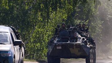 Ukrainian soldiers on top of an Ukrainian armoured fighting vehicle are pictured on a road in the countryside of Siversk, in Donetsk Oblast, eastern Ukraine, on July 8, 2022, amid the Russian invasion of Ukraine. (Photo by MIGUEL MEDINA / AFP) (Photo by MIGUEL MEDINA/AFP via Getty Images)