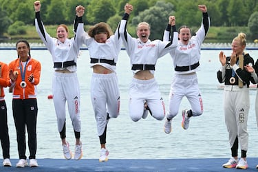 Great Britain's gold medallists (From R) Lauren Henry, Hannah Scott, Lola Anderson and Georgina Brayshaw celebrate on the podium during the medal ceremony after the women's quadruple sculls final rowing competition at Vaires-sur-Marne Nautical Centre in Vaires-sur-Marne during the Paris 2024 Olympic Games on July 31, 2024. (Photo by Bertrand GUAY / AFP)