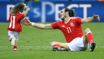 Wales' forward Gareth Bale watches his daughter Alba Viola running on the pitch following the team's 1-0 win in the Euro 2016 round of sixteen football match Wales vs Northern Ireland
