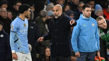Manchester City's Spanish manager Pep Guardiola gives in structino s to Manchester City's Egyptian striker #07 Omar Marmoush during the English Premier League football match between Manchester City and Chelsea at the Etihad Stadium in Manchester, north west England, on January 25, 2025. (Photo by Oli SCARFF / AFP) / RESTRICTED TO EDITORIAL USE. No use with unauthorized audio, video, data, fixture lists, club/league logos or 'live' services. Online in-match use limited to 120 images. An additional 40 images may be used in extra time. No video emulation. Social media in-match use limited to 120 images. An additional 40 images may be used in extra time. No use in betting publications, games or single club/league/player publications. /