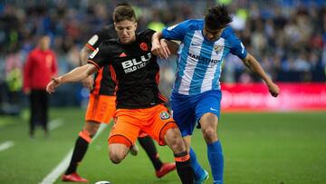 Valencia's Argentinian forward Luciano Vietto (L) vies with Malaga's Argentinian midfielder Gonzalo Castro "Chory" during the Spanish league football match between Malaga CF and Valencia CF at La Rosaleda stadium in Malaga on February