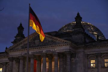 BERLIN, GERMANY - DECEMBER 07: The Reichstag, seat of the Bundestag, Germany's parliament, stands at dusk on the day police conducted nationwide raids against a suspected insurrectionist group on December 07, 2022 in Berlin, Germany. Law enforcement agencies conducted raids nationwide today and arrested 25 people whom they claim are in an organization bent on violently overthrowing the German government. According to Germany's prosecutor general, the group is driven by a mix of conspiracy theories and far-right ideology, including influence of the Q-Anon and Reichsbrger movements. Among its members are former members of an elite military unit and former police. The leader of the group is reportedly a German aristocrat named Heinrich Reuss, also known as Prince Heinrich XIII, who was to lead the new government following an insurrection. (Photo by Sean Gallup/Getty Images)