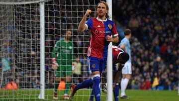 Basel's Swiss defender Michael Lang celebrates scoring their second goal during the UEFA Champions League round of sixteen second leg football match between Manchester City and Basel at the Etihad Stadium in Manchester, north west England, on March 7